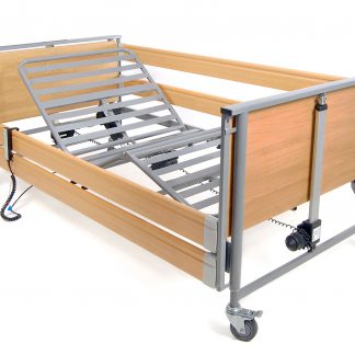 Harvest Woburn Community Profiling Bed in the profiled position with side rails up on left lying side and down on the right lying side