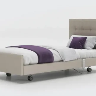 Opera Signature Comfort Profiling Bed - Flat, at its lowest position, made up with white bedding with a purple throw across it with a matching purple pillow