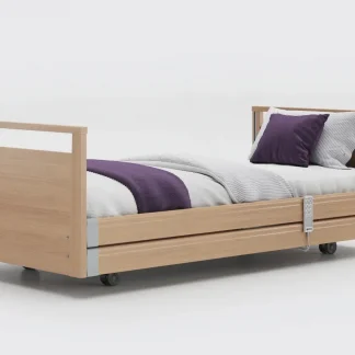 Opera Signature Profiling Bed in flat position with bedding on and side rails lowered.