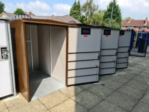 3 mobility scooter storage boxes side by side with their doors open with the handle on the left hand side
