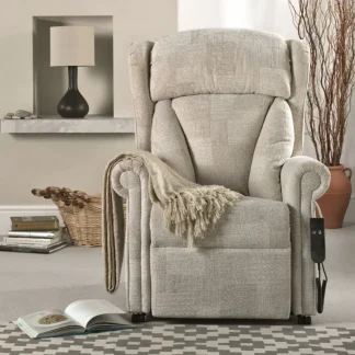 Repose Chepstow Riser Recliner - in a room setting in the upright position with a throw draped across the armrest and a book on the floor