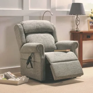 The Repose Kensington Riser Recliner is pictured in a room setting with a reading lamp attached to the back of the chair