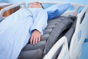 patient lying on the Wellell Optima Turn Mattress being turned