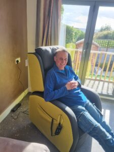 Paul, Owner of Crescent Hideaway, modelling their riser recliner chair