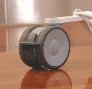Close up on the Tenth Castors on Oxford Hoists - On a wood floor so polished you can see the reflection of the castor