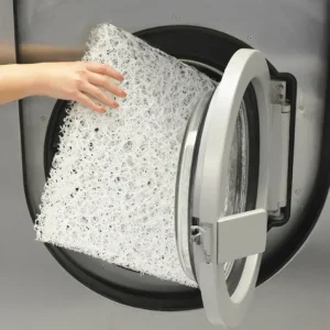 Nest Technology - a Nest Seat Cushion being placed into a washing machine
