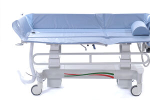 the side rail on the Time Shower Trolley has been lowered so as to obtain easier access to the patient