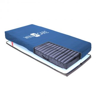Winncare Caithness™ Dynamic Mattress with a stretchable, vapour permeable cover, mattress is flat and there is a cut out in the bottom left quarter to reveal the air cells within.