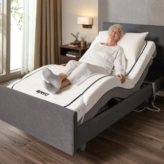 Adjustable bed raised with Opera Flexi electric blanket fitted while a user relaxes comfortably