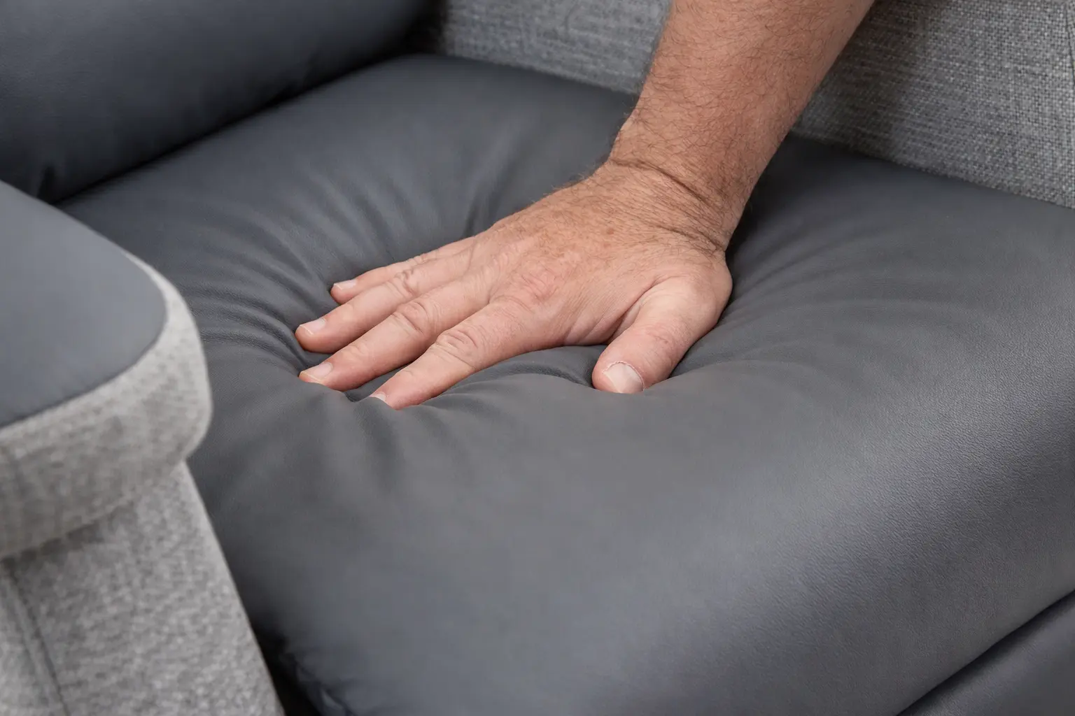 Pressure relieving riser recliner chair cushion Close-up of hand pressing into supportive riser recliner chair cushion showing pressure relief and comfort
